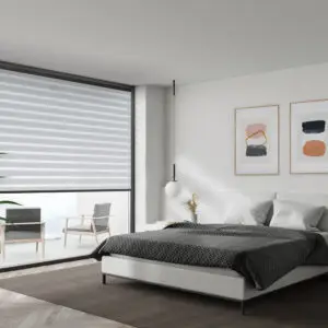 Modern bedroom with large windows covered by dual zebra shades in light grey tones.