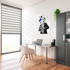 Modern office interior with zebra roller shades on tall window, desk with laptop, and minimalist furniture
