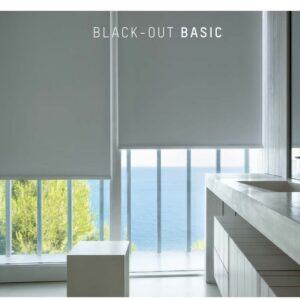 Modern bathroom with large windows covered by white blackout roller shades, ocean view in the background.